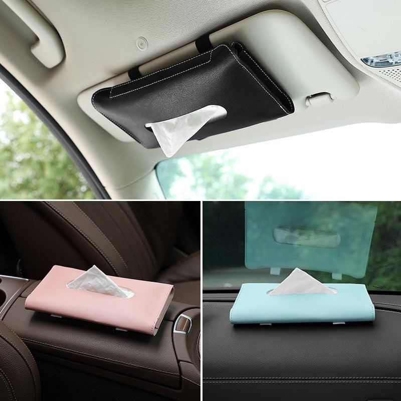 Black car sun visor tissue holder clipped to a visor
