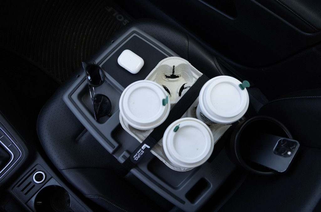 Stupid Car Tray holding takeaway cups and small items on a passenger seat
