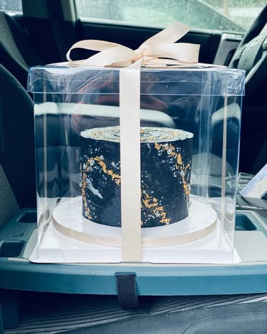 Cake box secured on a Stupid Car Tray with an elastic strap